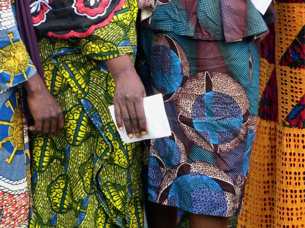 Women wait to cast their ballots at a polling station during the Guinea"s presidential election in Fria, Guinea October 18, 2020.