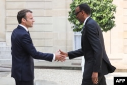 FILE - France's President Emmanuel Macron, left, welcomes Rwanda's President Paul Kagame upon his arrival at the Elysee presidential palace in Paris, May 23, 2018.