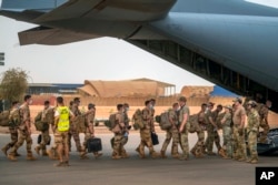 FILE - French Barkhane force soldiers who wrapped up a tour of duty in the Sahel leave their base on a transport plane in Gao, Mali, June 9, 2021. French President Emmanuel Macron announced Feb. 17, 2022, that he is withdrawing French troops from Mali.