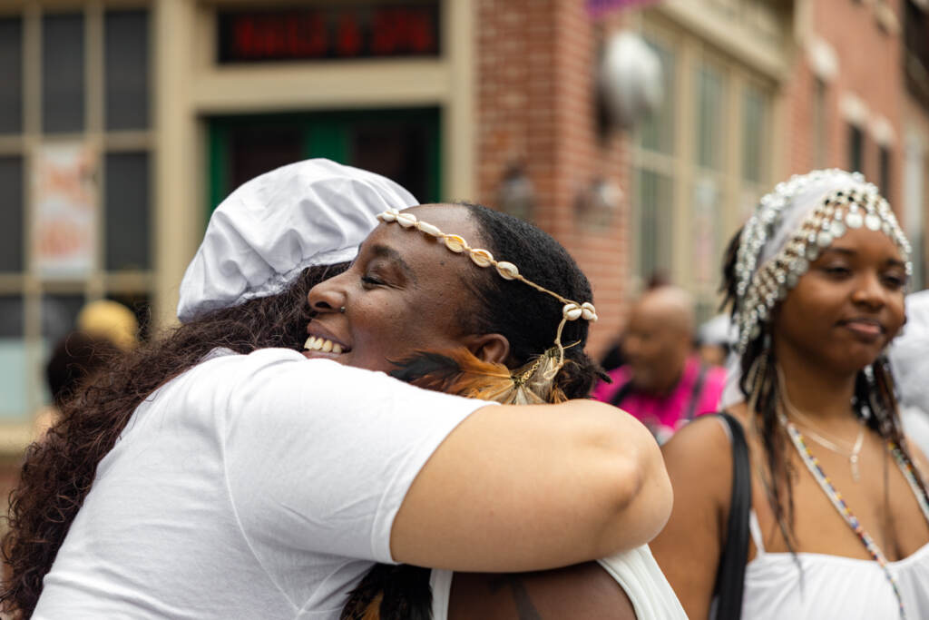 Two women hug during the Odunde Festival in Philadelphia.