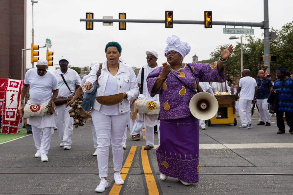 Two women lead the Odunde procession onto the South Street Bridge.