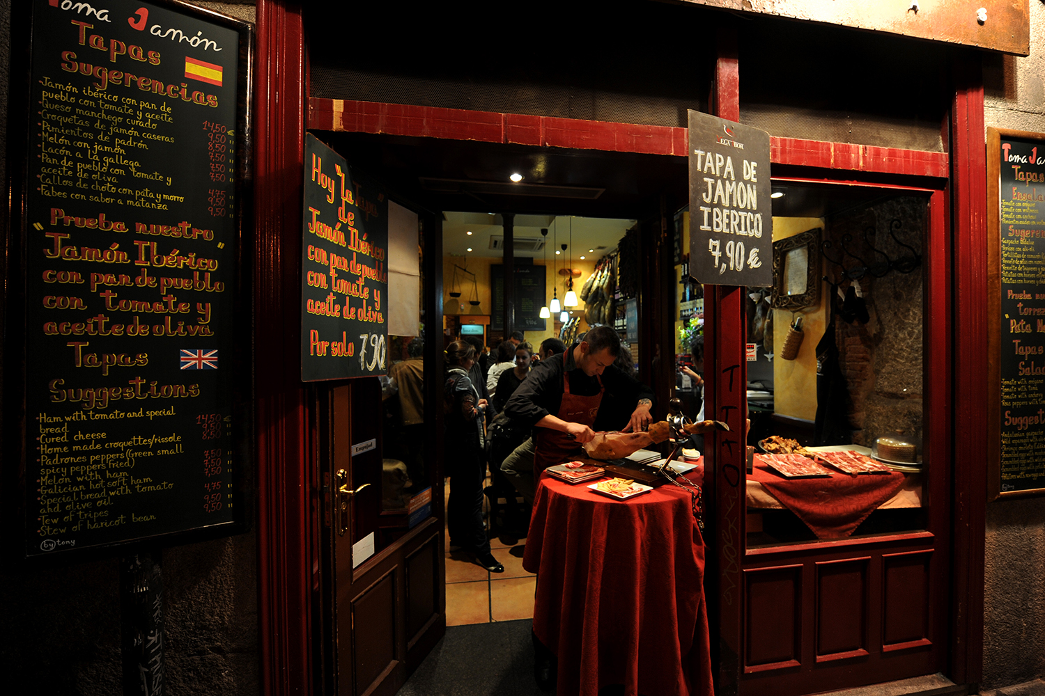 A waiter cuts Jamon Iberico at the entrance of one of the many tapas bars at Calle Cava Baja on Oct. 23, 2009 in Madrid, Spain.